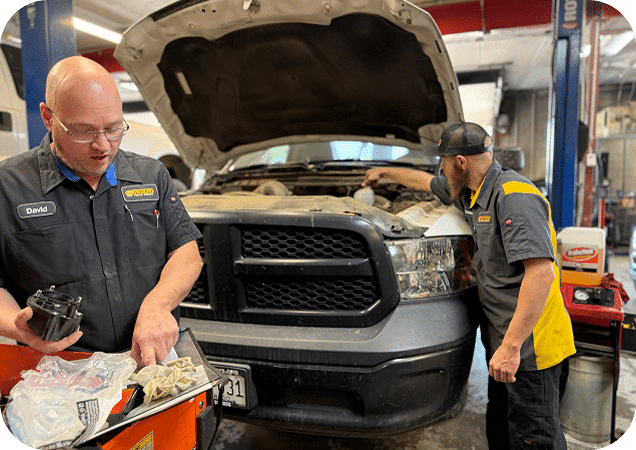 Aspen Auto Clinic technicians inspecting a customer's vehicle